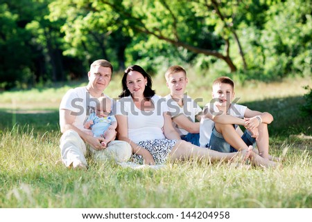largest family rest on the nature. Happy family walks in the woods