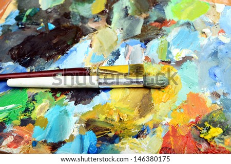 Palette with paint brush and tubes of oil paint