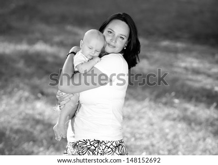 A child in the arms of mother. black and white photo