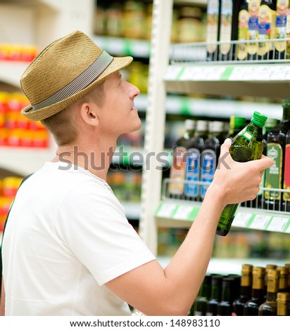man buys  products at the supermarket
