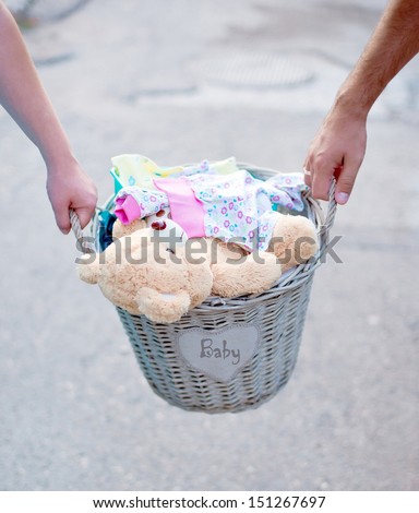 Things for the newborn. basket of baby clothes.