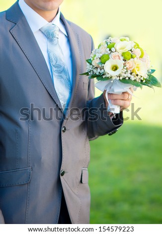 man with a bouquet of flowers. wedding.