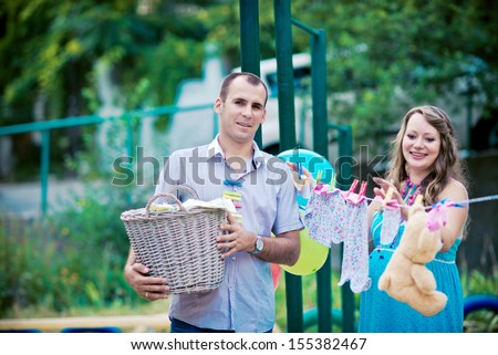 laundry basket with fresh air. Pregnant woman hangs laundry