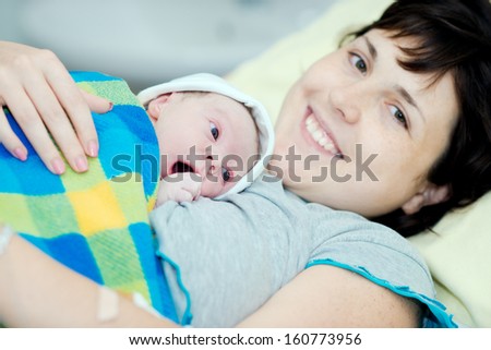 Woman With A Newborn Baby. Birth In Hospital. Baby After Birth. Child One Day.