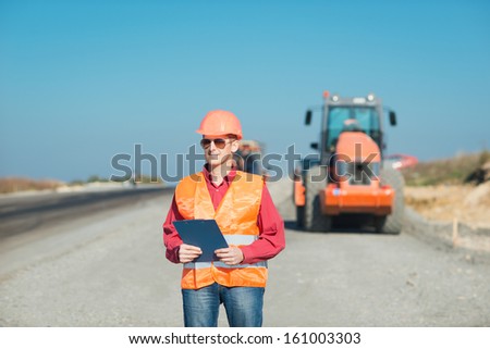Portrait of a happy young engineer. Engineer in a construction helmet