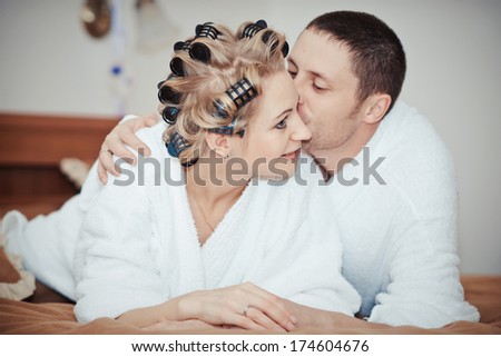 Man and woman lie on bed. cheerful beautiful couple