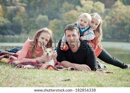 Happy family resting park. Children walk in the park with his father