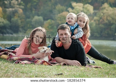 Happy family resting park. Children walk in the park with his father