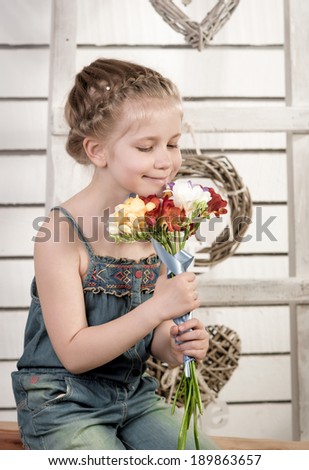 Portrait of beautiful girl. Studio photo.Beautiful little girl with a bouquet of flowers.