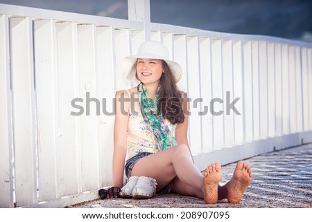 Portrait of young happy beautiful girl outdoors in sunny summer day
