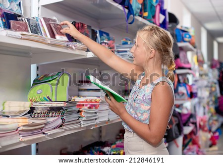 Schoolgirl buys exercise book Office goods in store for school