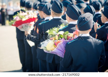 cadet school students on the parade with a bouquet of flowers