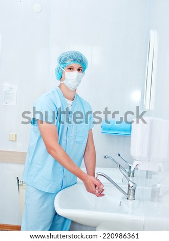 Male surgeon washes his hands before the operation