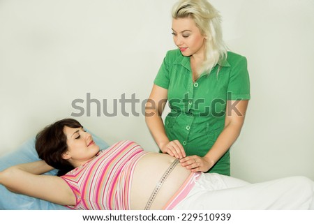 Pregnant woman at the doctor, Measuring the circumference of the abdomen