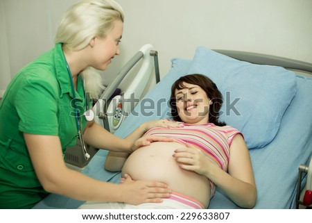 Pregnant woman in childbirth. pregnant woman on reception at the doctor...