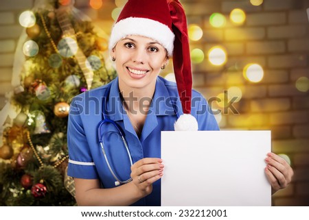Portrait of smiling doctor woman in santa hat. Doctor - christmas
