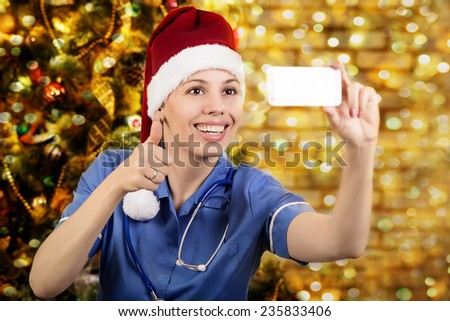 Doctor in cap of Santa. photographs the itself