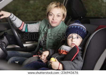 little boy in a a car seat, family in the car