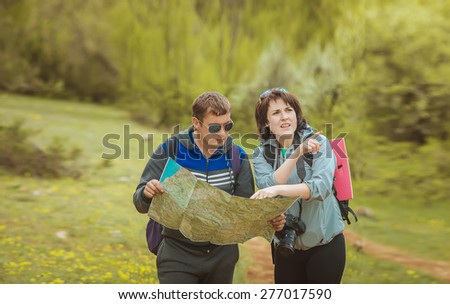 tourists with a map in the forest