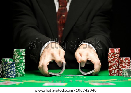 casino worker shuffling cards