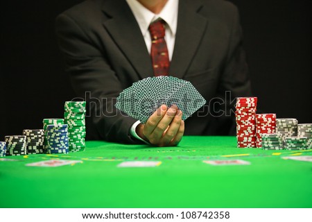 casino worker holds cards