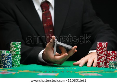 casino worker shuffling cards
