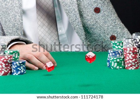 Red dice are rolling on casino table