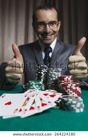 Royal Flush,Businessman, Won In Poker Game And Show Thumbs Up