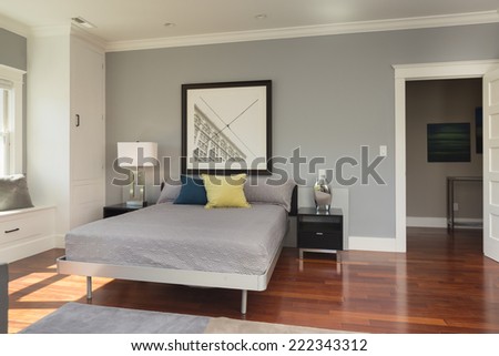 Master bedroom in luxury home with cherry wood flooring