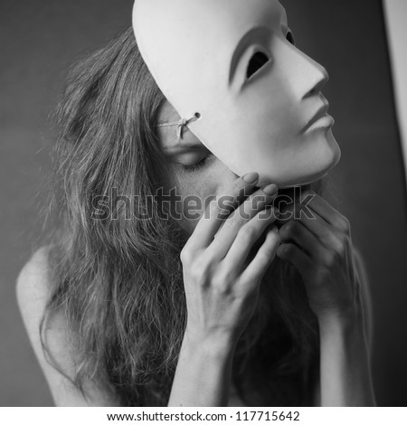 a beautiful model with white mask -  volto bianco. studio shot with daylight.