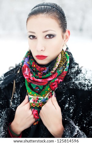 Winter girl in black fur coat with luxury fashion accessories. Outdoor shot.