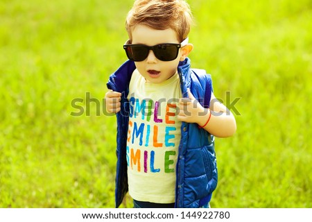 Stylish Baby Boy With Ginger (red) Hair In Trendy Sunglasses And Blue 