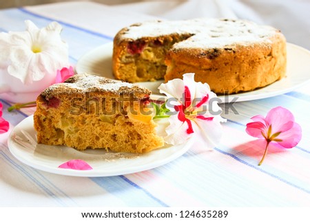 A piece of cake and pie with apples decorated with flowers