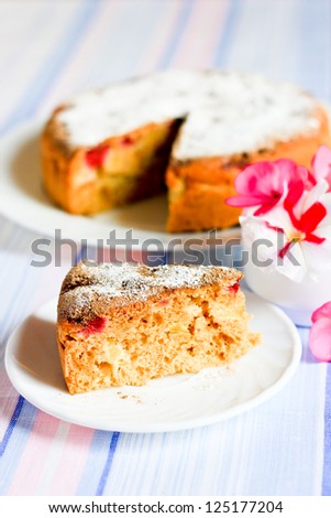A piece of cake and pie with apples decorated with flowers