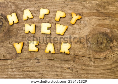 Cookies paste the text Happy New Year on the old wooden floor.