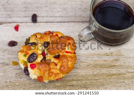 top view delicious mix dried fruit bread  on foil cup and black coffee on old wood table