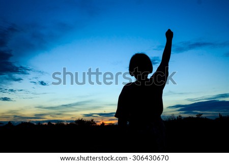 Children silhouettes holding hand up
