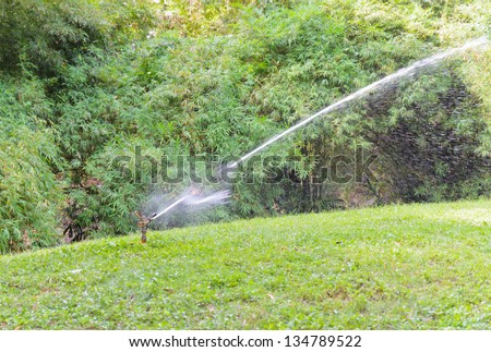 Sprinkler system is watering the lawn in the park