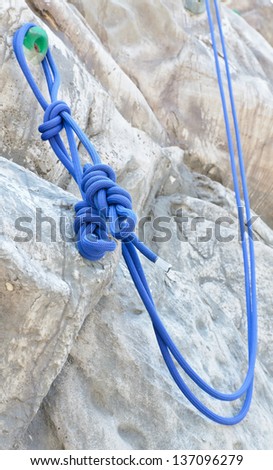 Rope with Artificial rock climbing wall background