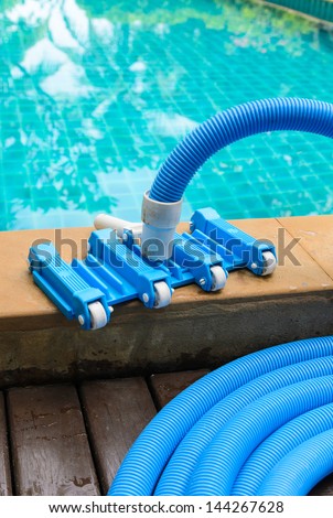 Pool vacuum cleaning flexible hose on the pool