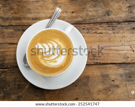 Art coffee .Cappuccino Coffee on Wooden table background