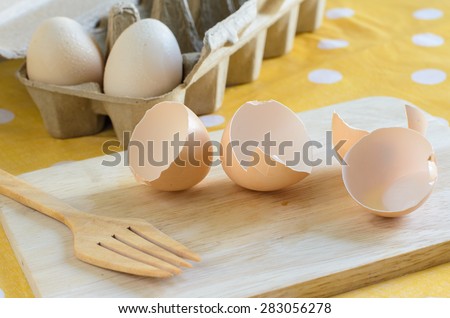 Cooking eggs for preparation on wooden cutting board