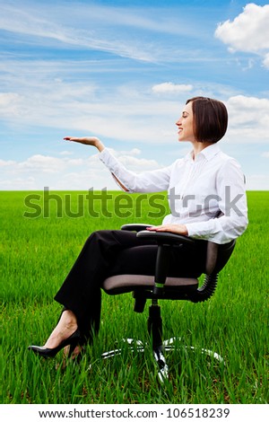 beautiful businesswoman sitting on recliner and holding something on her hand