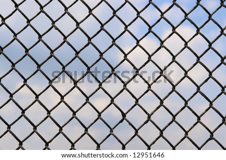 fence of metallic net and blue sky