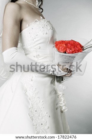 elegant bride with bunch of roses over grey background