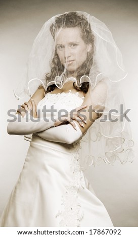 beautiful bride hiding her face behind an wedding veil