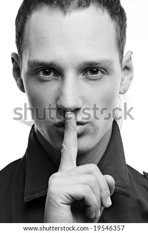 stock photo black and white portrait of handsome man hushing over white