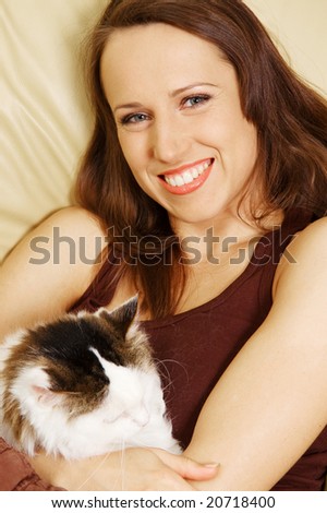 smiley woman with her pet on the sofa