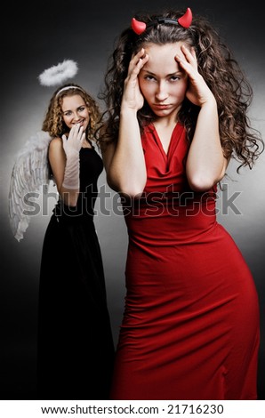angel and devil over dark background