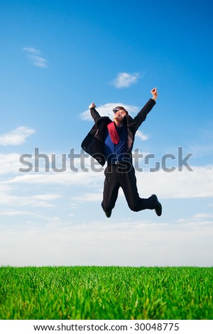 lucky businessman in jump against blue sky